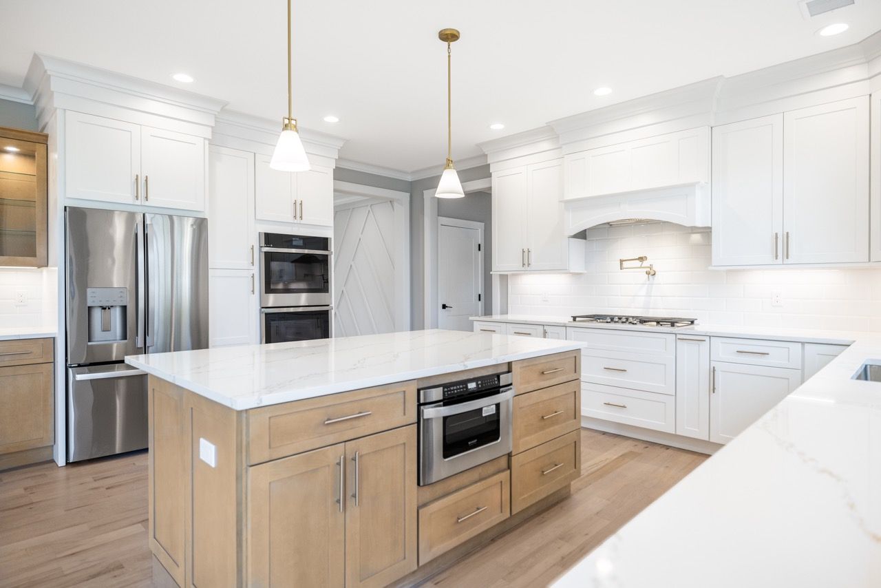 Open kitchen with white cabinets and a wood island