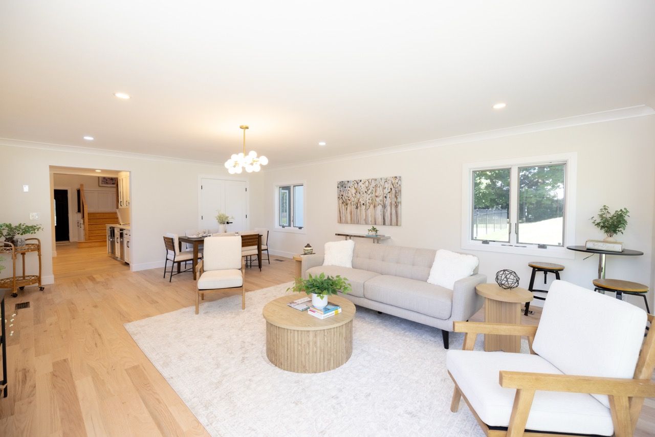 Staged living room with light wood floors
